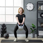 12 kg kettlebell held by a person on a home gym mat, blue handle visible