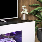 White TV cabinet interior with LED-lit shelves and open compartments for media items
