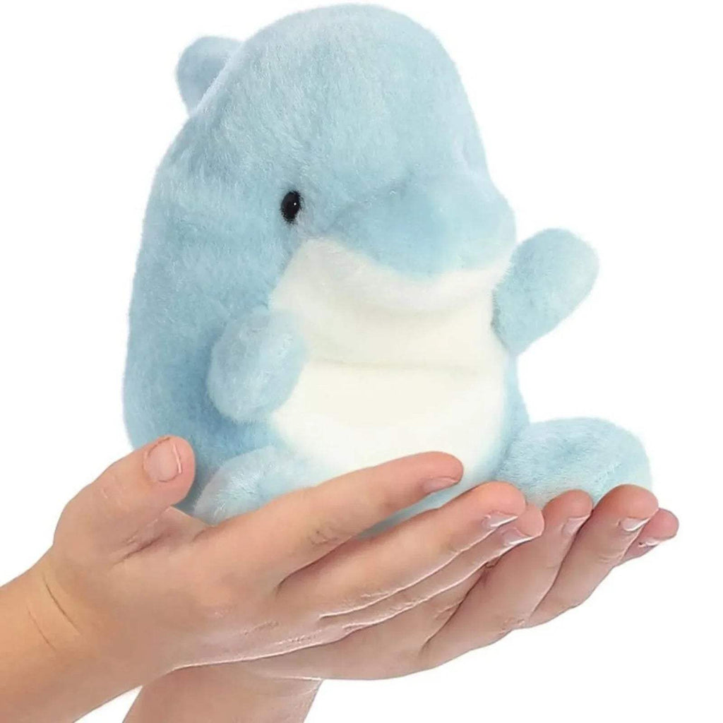 Light blue plush dolphin toy held in hands, with white belly and rounded flippers