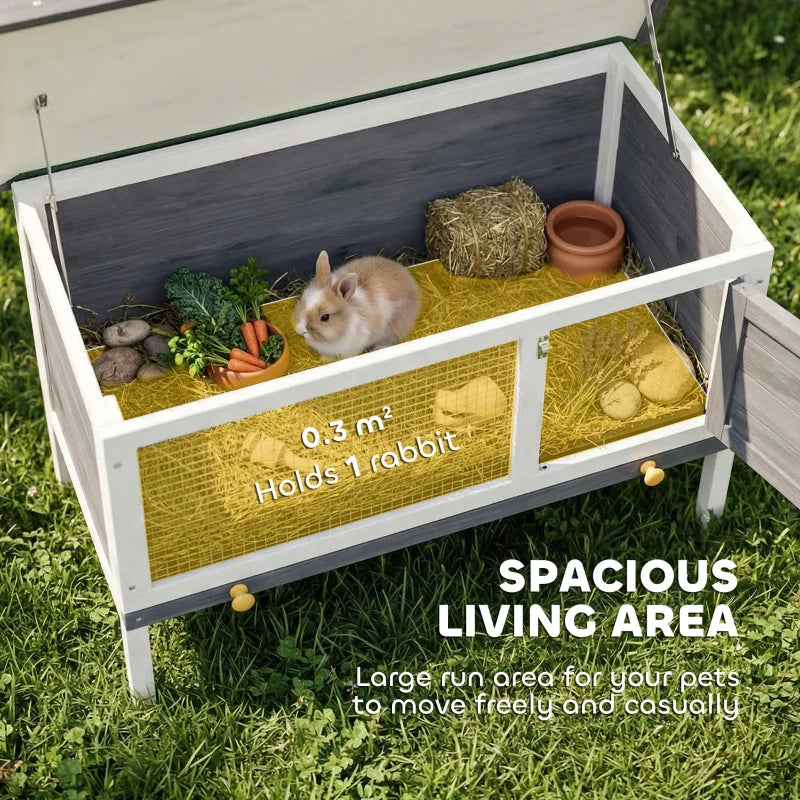 Open grey wooden rabbit hutch interior with hay, bedding, and access tray space
