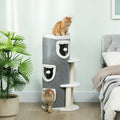 Gray cat tree with barrel condos and sisal posts, kitten standing at base