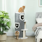 Gray cat tree with barrel condos and sisal posts, kitten standing at base