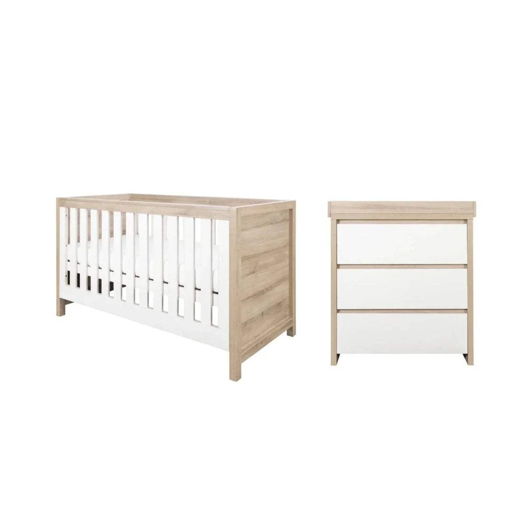 White and oak baby cot bed and matching 3-drawer dresser shown together