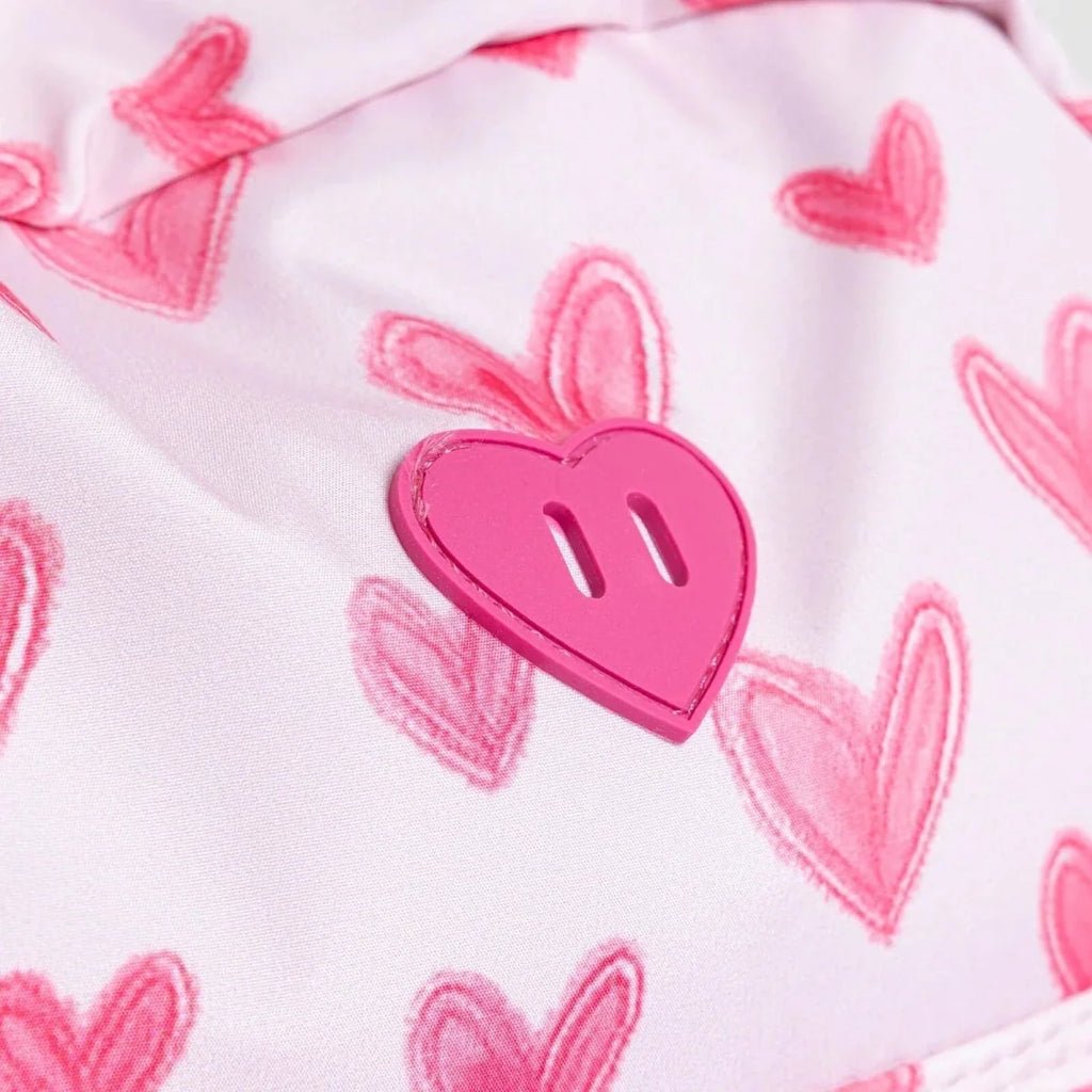 Pink heart print fabric detail with heart-shaped button