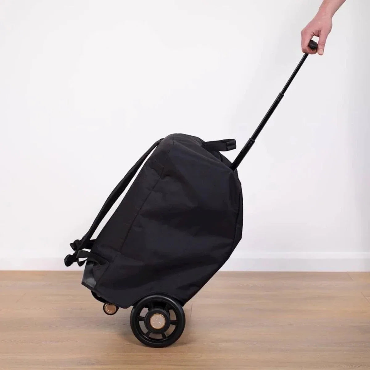 Black stroller bag on wheels with pull strap and top carry handle
