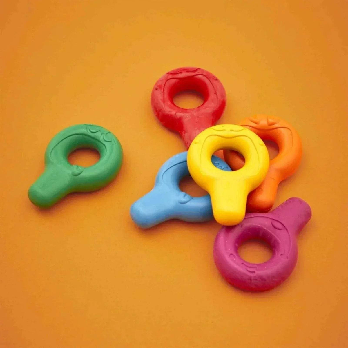 Five chunky crayons in green, red, yellow, orange, and purple