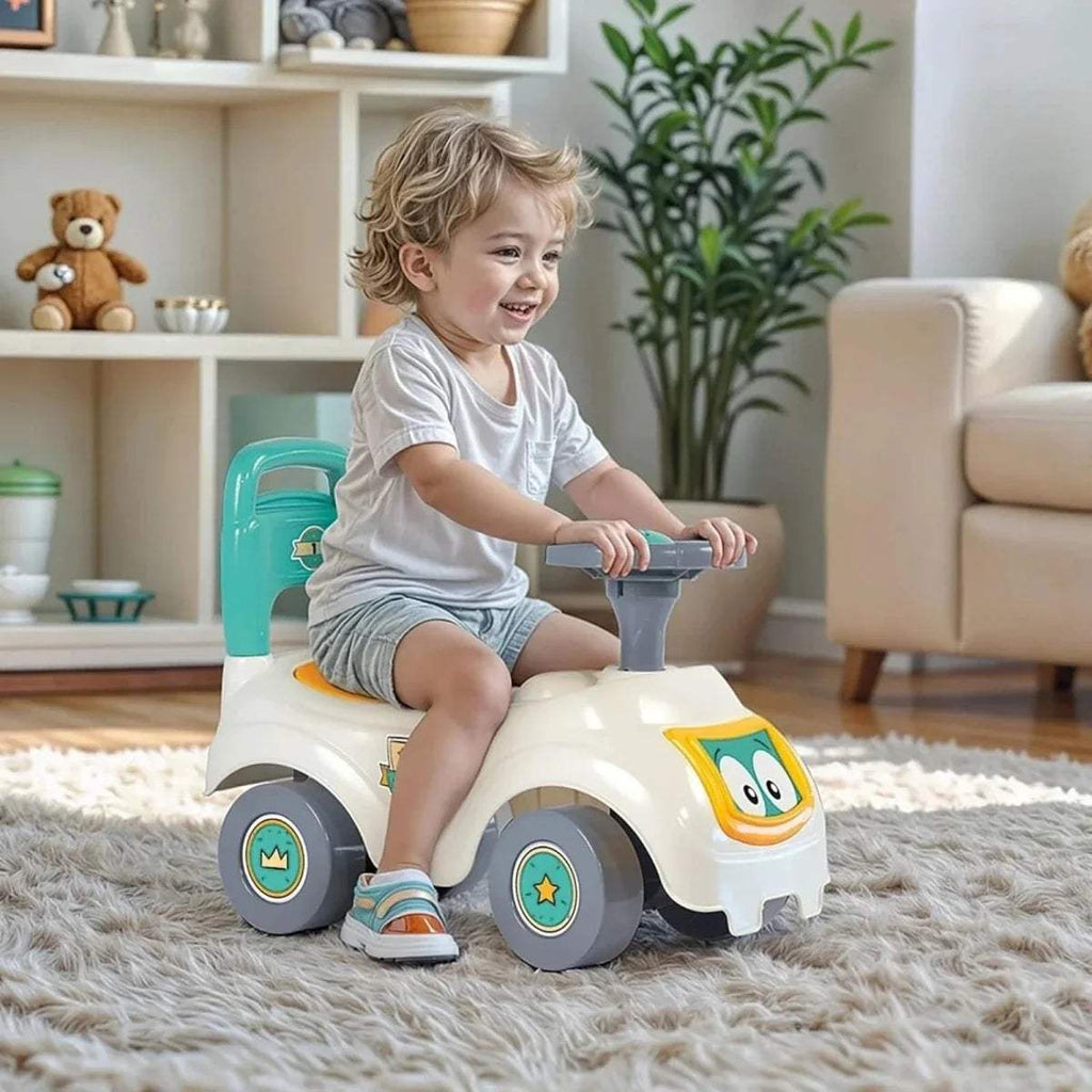 Child sitting on white Dolu sit-and-ride car with teal handle and character front