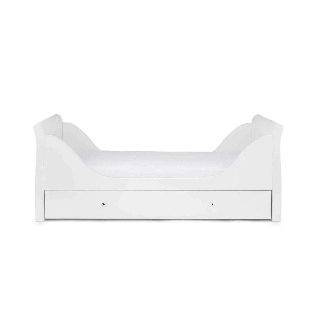 White cot bed with curved end panels, slatted rail sides, and drawer base.