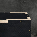 Top view of black wooden jump box platform with light wood support strips