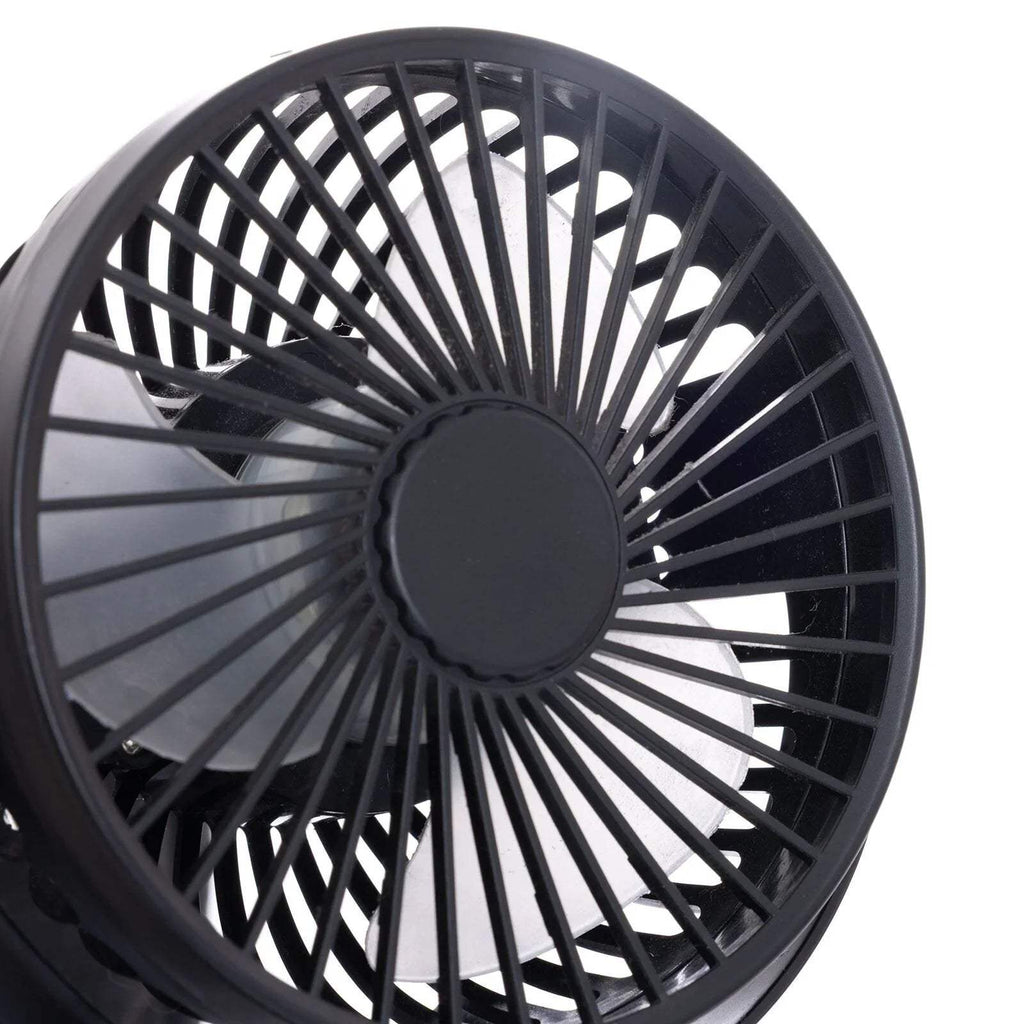 Close-up of black fan grille with circular center and radial blades