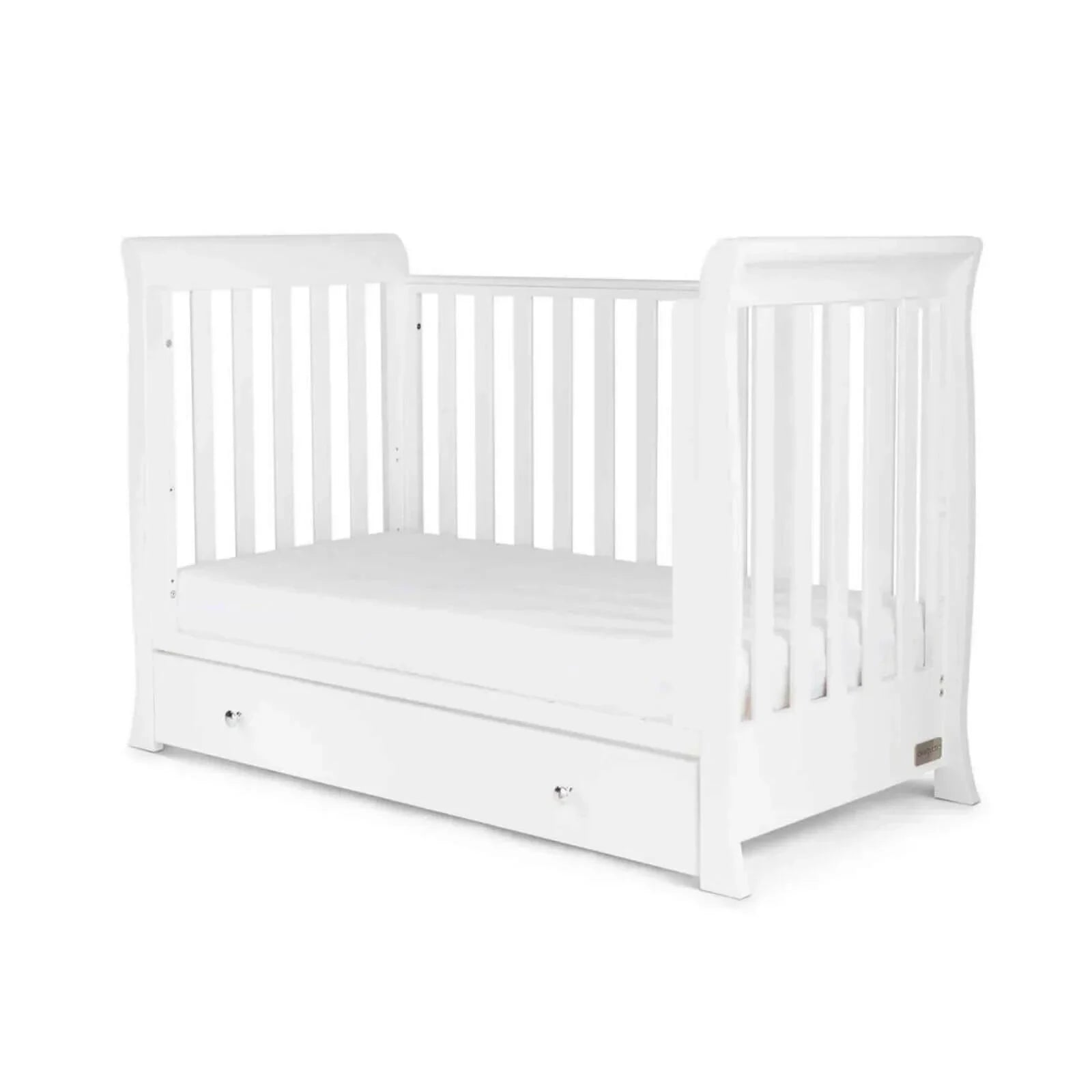 White mini cot bed with slatted sides and drawer front, includes sprung mattress