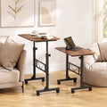 Two adjustable sofa side tables with rustic brown tops and black rolling bases