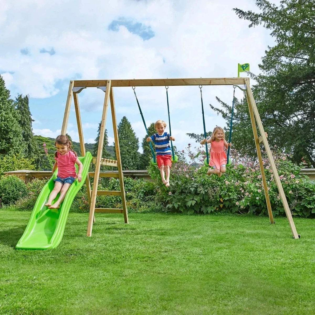 Outdoor wooden swing set with green slide and two hanging swings