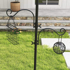 Black bird feeding station pole with hanging wire feeder and spherical feeder cup