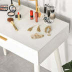 White dressing table top with cosmetics and accessories, gold handle detail visible