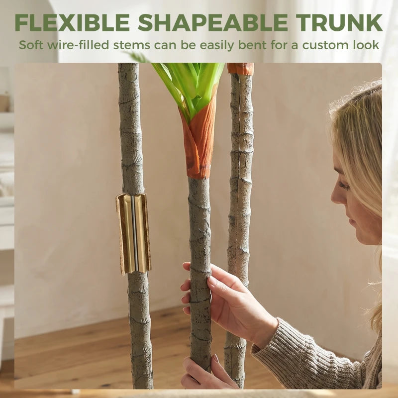 Flexible artificial dracaena trunks with green leaves in a white pot.