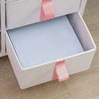Open gray fabric drawer bin on pink-topped storage cabinet frame, pink tab handle