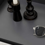 Dark grey shoe cabinet top surface with decorative objects