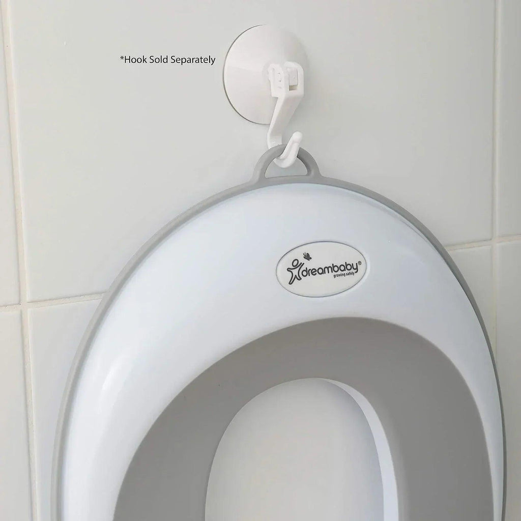 Dreambaby toilet trainer seat front view with oval opening and hanging hook