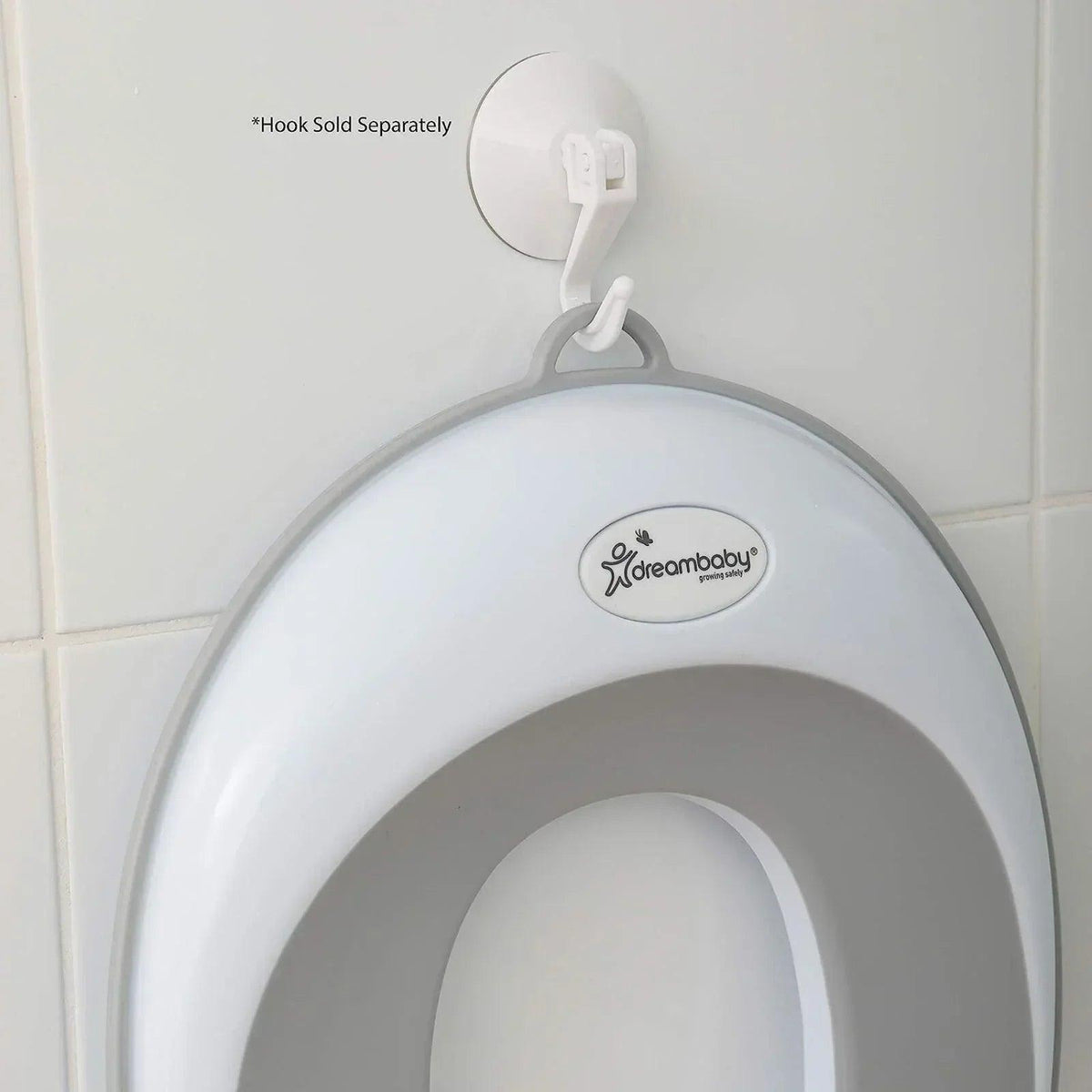 Dreambaby toilet trainer seat front view with oval opening and hanging hook