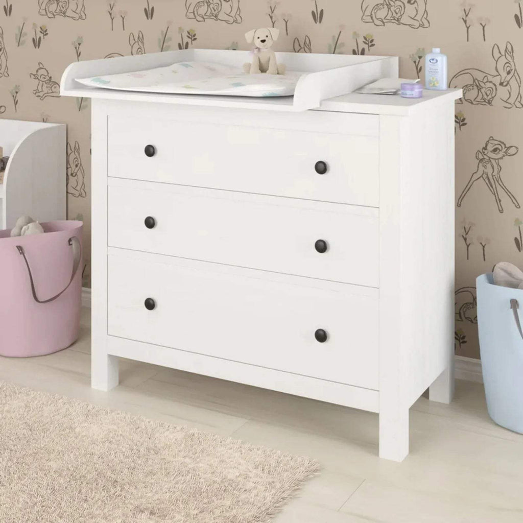 White dresser with 4 drawers and baby changing top with raised edges