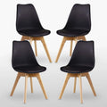 Set of 4 black upholstered dining chairs with curved backs and light wood tapered legs