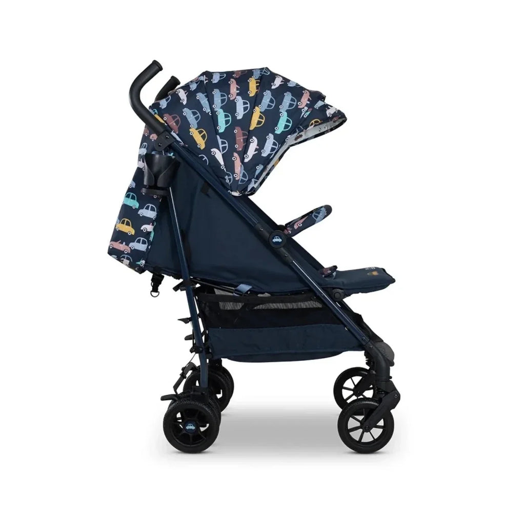 Baby stroller with patterned canopy and navy seat, side view with safety bar visible