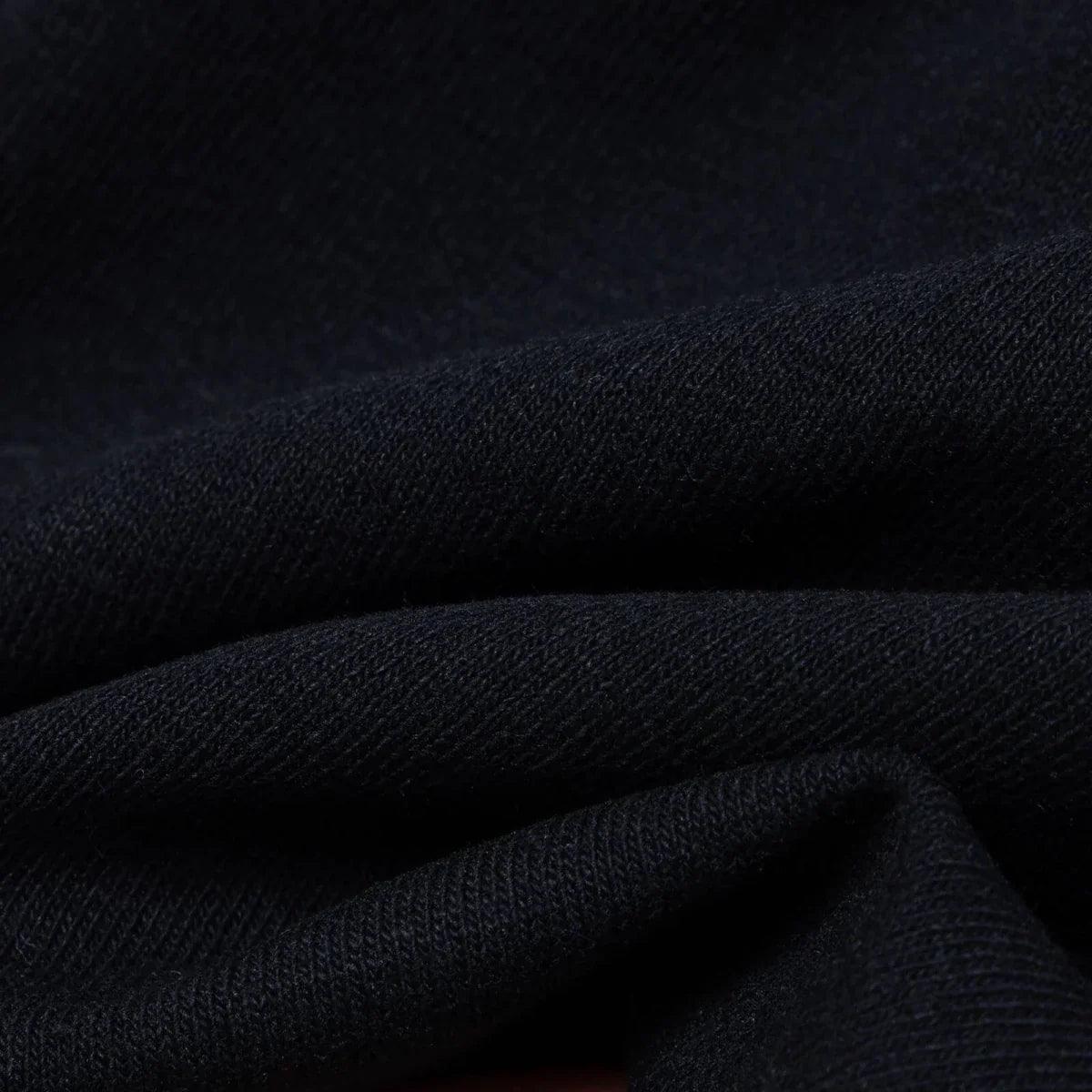 Black jersey fabric detail with soft knit texture and close weave