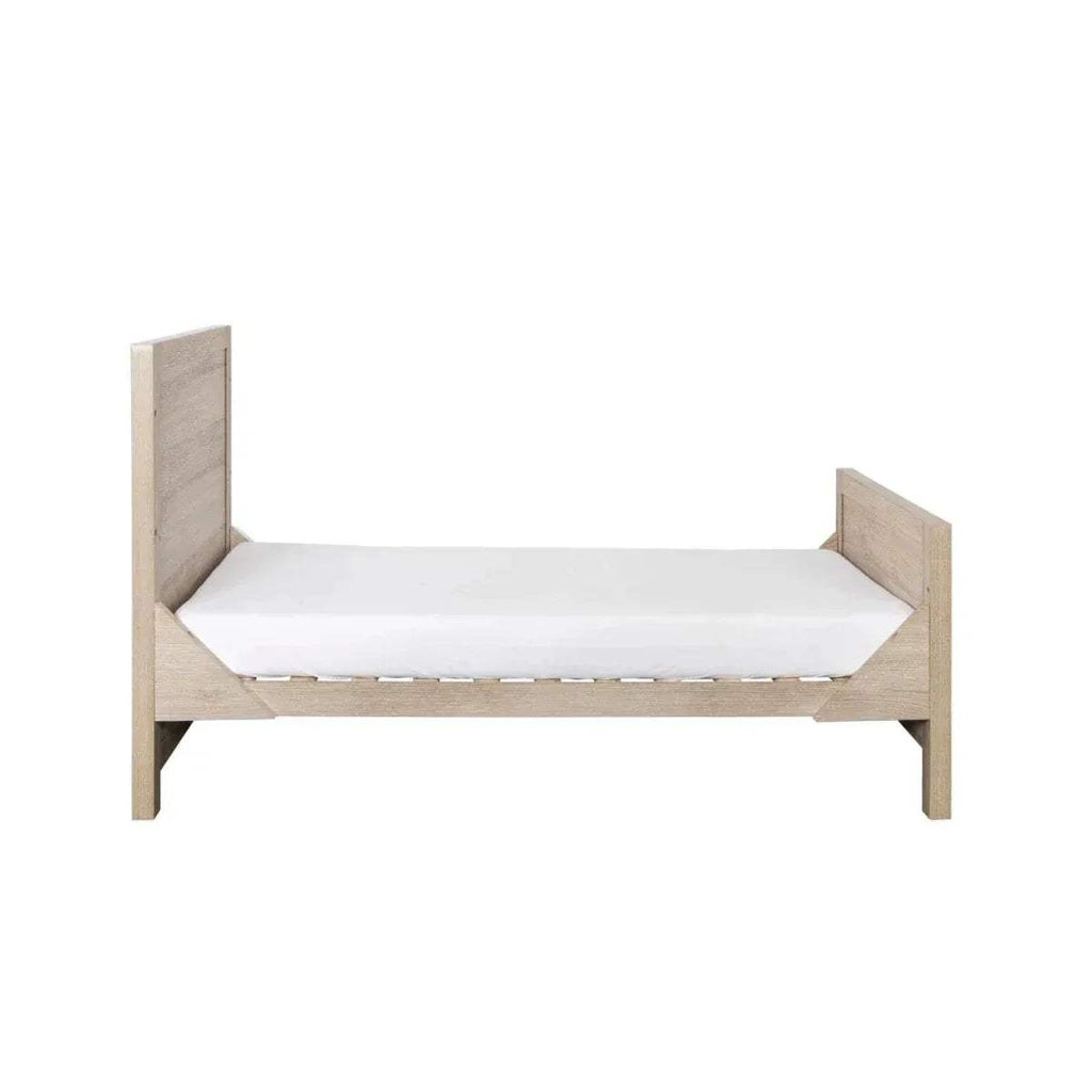 Oak junior/sofa-style bed with two end panels, slatted sides, and white mattress base