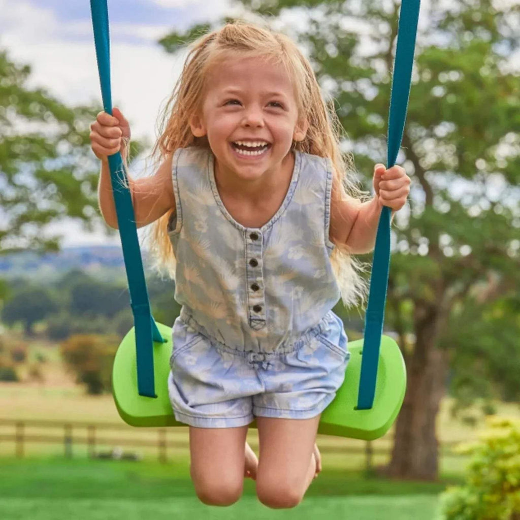 Child on green swing seat holding blue ropes; wooden swing frame overhead.