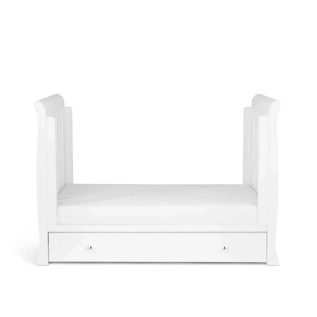 White mini cot bed with slatted side rails and front drawer with two handles