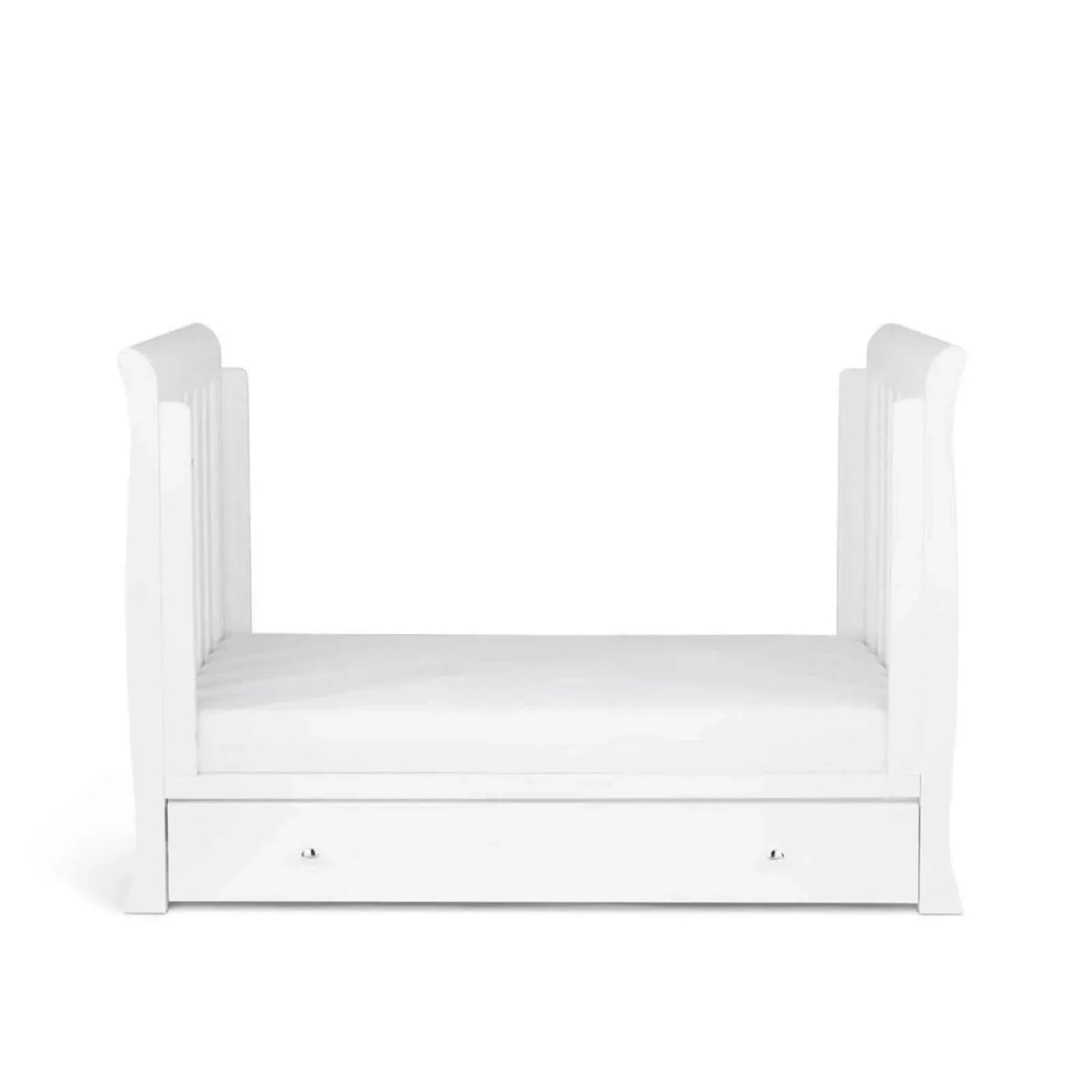 White mini cot bed with slatted side rails and front drawer with two handles