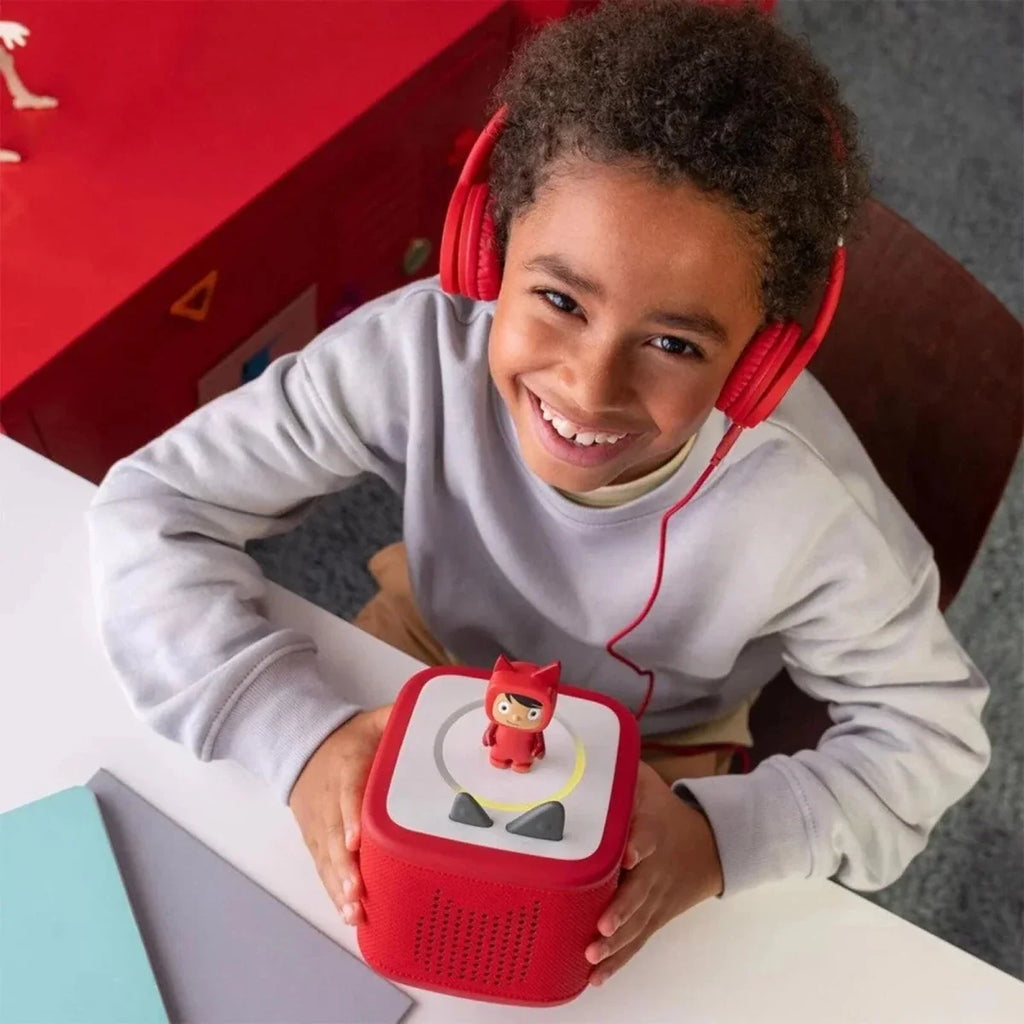 Red Toniebox 2 being held, with Creative Tonie figure on the top