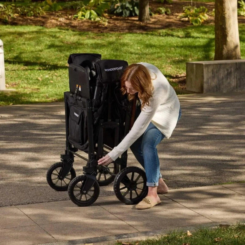 Jet black stroller wagon with folded canopy and four-wheel base