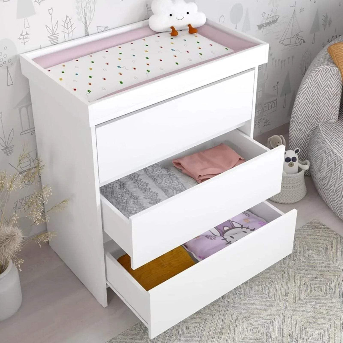 White baby changing unit with raised changing surface and two storage compartments
