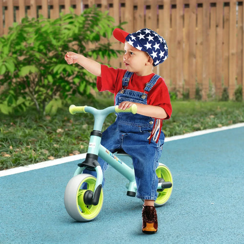 Child riding a light green balance bike with black seat and lime wheels on road