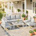 White 5-piece outdoor seating set with gray cushions, armchairs, and coffee table