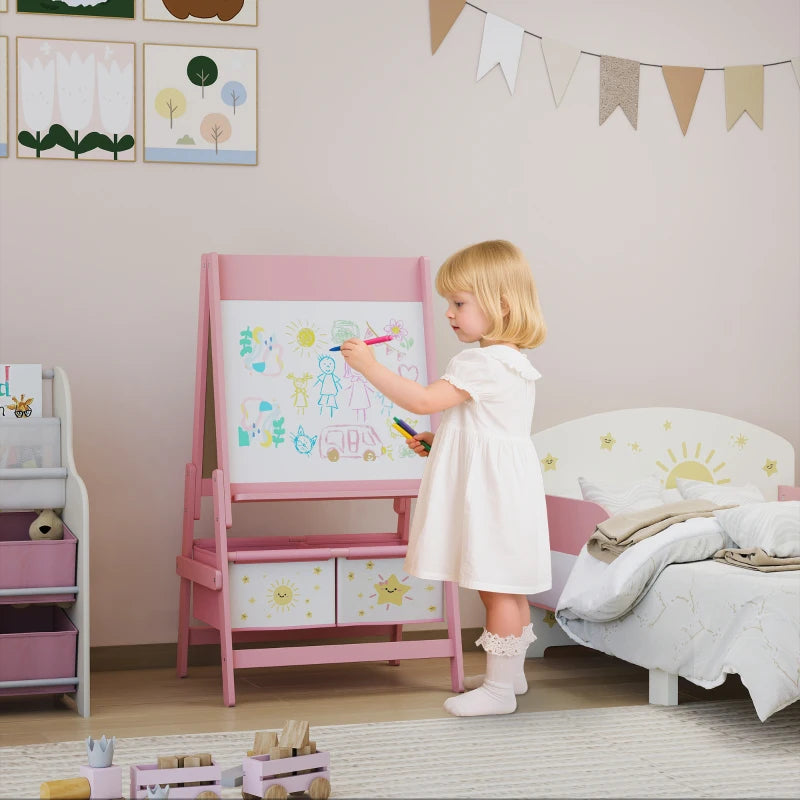Pink kids art easel with whiteboard panel and front storage bins while a child draws