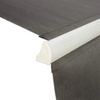 Close-up of grey awning fabric edge on white roller housing with stitched seams