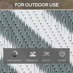 Reversible outdoor mat with grey-and-white woven plastic straw chevron pattern