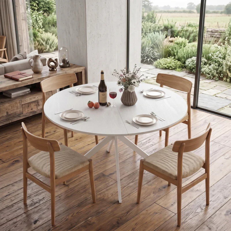 White round dining table with central X legs and four wooden chairs