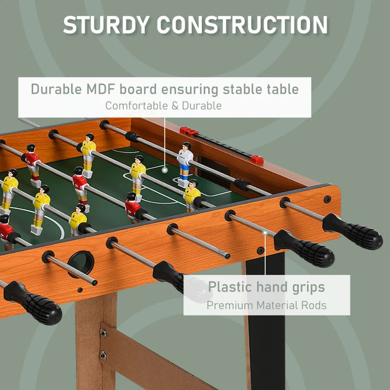 Foosball table with plastic hand grips on black rods and green pitch