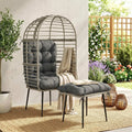 Light grey egg lounge chair with thick cushions and matching footstool on legs