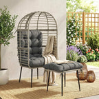 Light grey egg lounge chair with thick cushions and matching footstool on legs