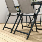 Grey folding patio dining chair with armrest latch and dark frame