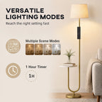 Gold-tone floor lamp with linen shade and round side shelf on curved base