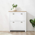 White narrow shoe cabinet with wood top, two drawers, and silver curved handles