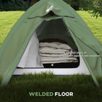 Green dome camping tent with open doorway showing layered interior sleeping space.
