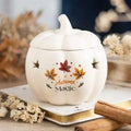 Cream pumpkin-shaped oil burner with lid, cutout stars, and 'Autumn Magic' design