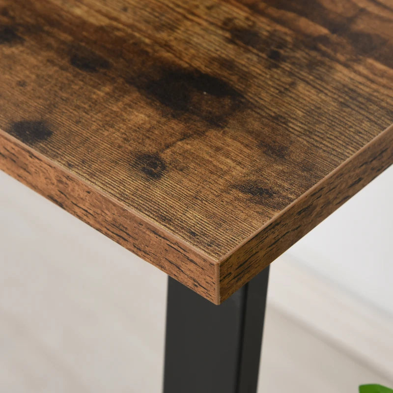 Close-up of brown wood-grain tabletop edge on black metal desk frame